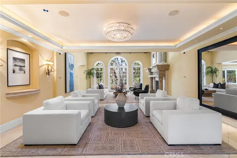 a living room with fireplace furniture and a large window