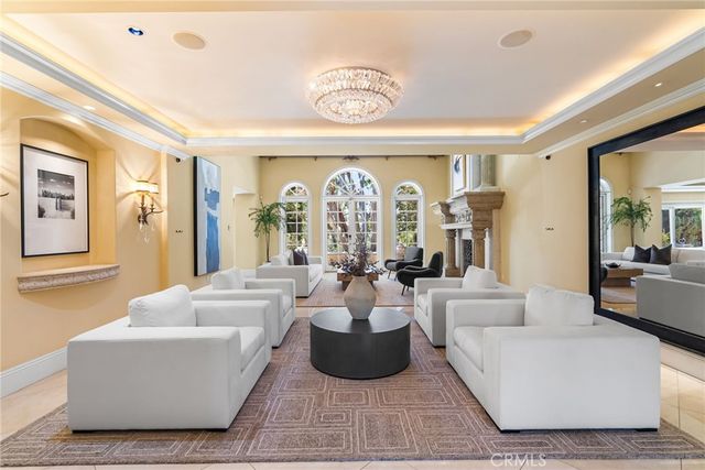 a living room with fireplace furniture and a large window