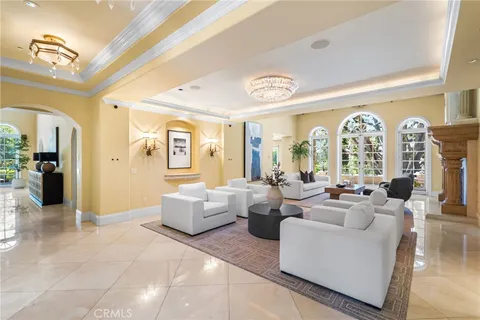 a spacious bedroom with a bed couches and a large window with garden view