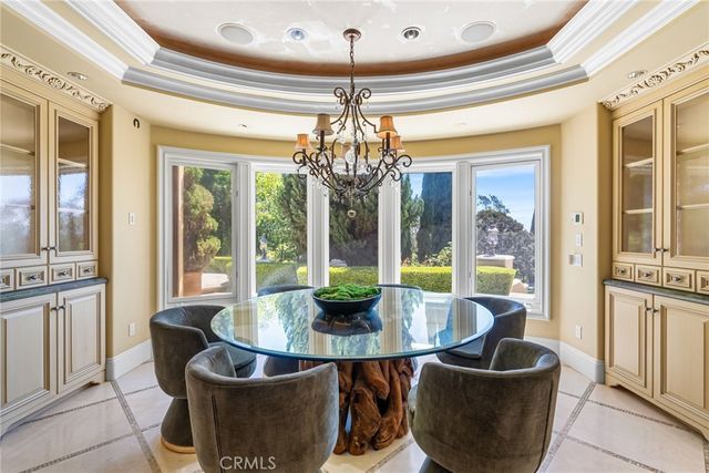a dining room with furniture a chandelier and window