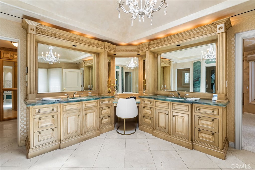 26501 Silver Saddle Lane Laguna Hills, CA 92653 - Photo 31 of 59 a large bathroom with a double vanity sink a mirror and a bathtub
