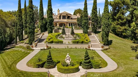 a view of a backyard with couches plants and large tree