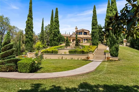 a living room with furniture and floor to ceiling windows