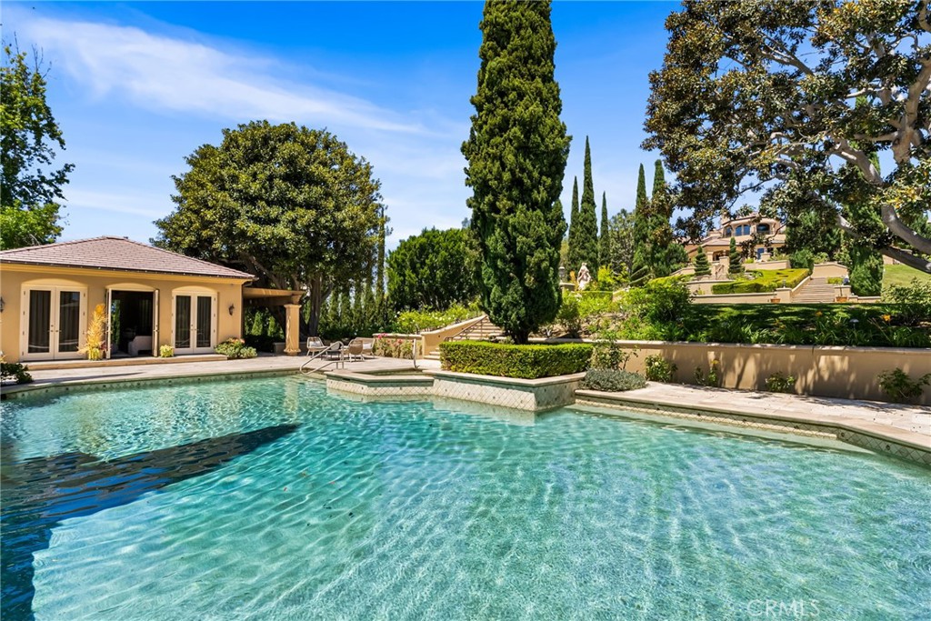 26501 Silver Saddle Lane Laguna Hills, CA 92653 - Photo 43 of 59 a view of swimming pool with lawn chairs and plants