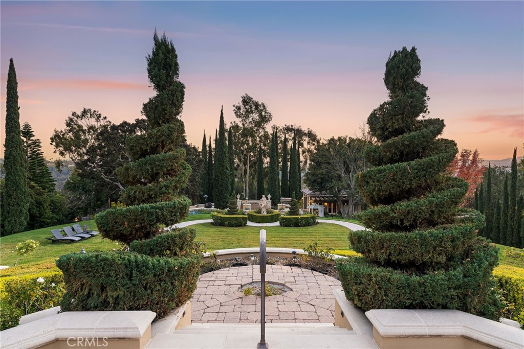 26501 Silver Saddle Lane Laguna Hills, CA 92653 - Photo 7 of 59 a view of a swimming pool with a garden