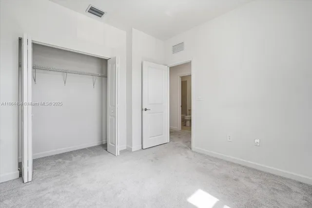 a bathroom with a sink toilet vanity and shower