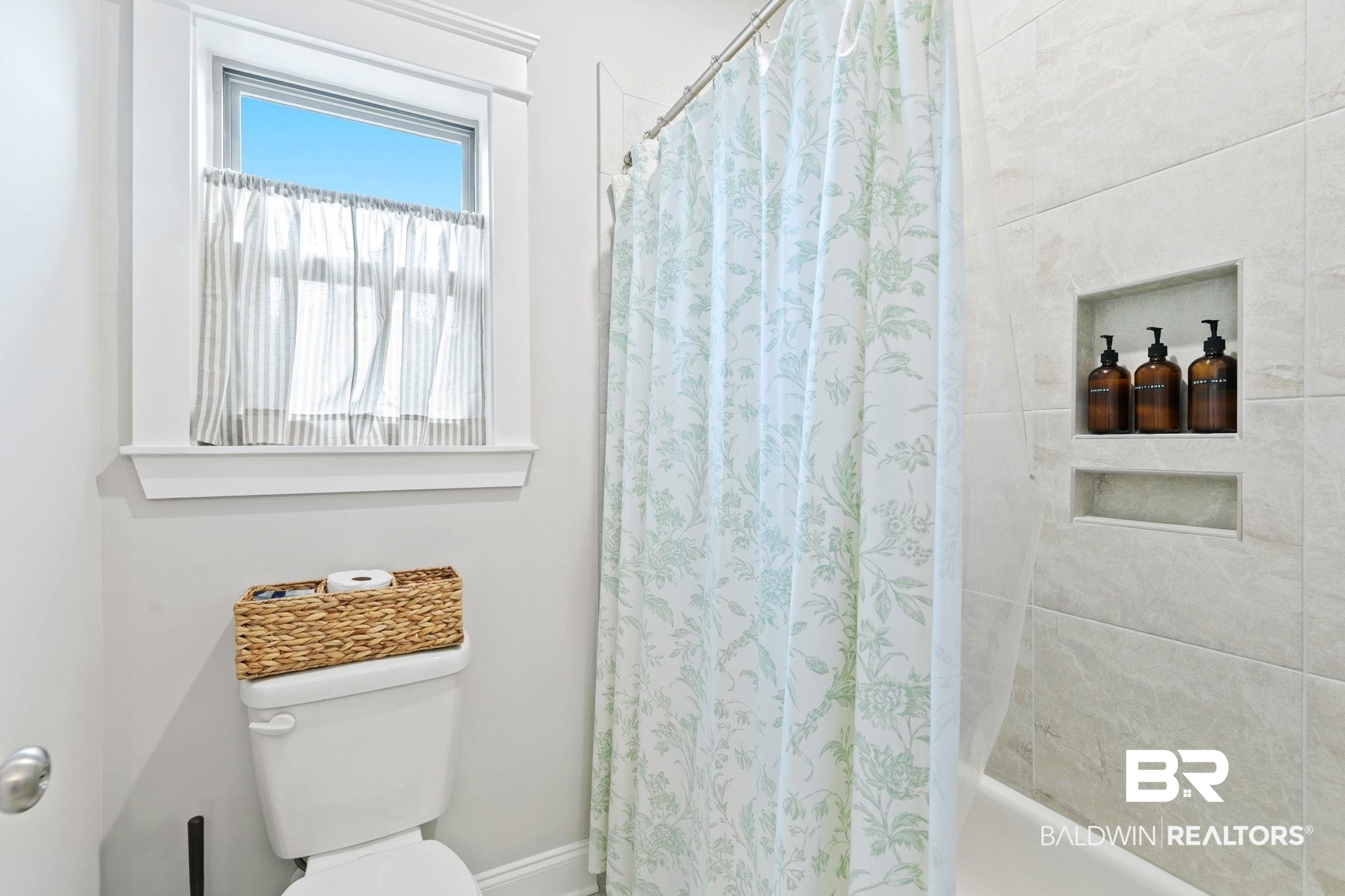 13233 Ibis Boulevard Daphne, AL 36527 - Photo 49 of 100 Bathtub with shower enclosure featuring light-toned tile surround and recessed shelving