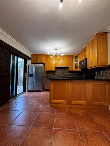 a view of a kitchen with a sink and cabinets