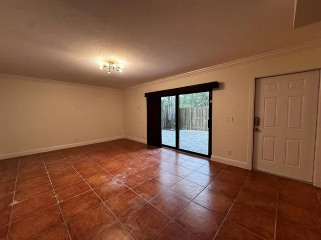 a view of an empty room and glass door
