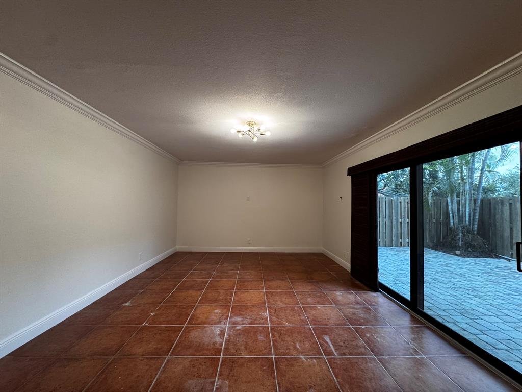 3205 Spanish Wells Drive, Unit C Delray Beach, FL 33445 - Photo 20 of 20 a view of an empty room with wooden floor and a window