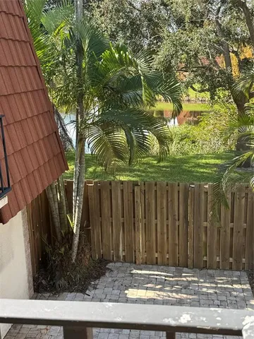 a view of a house with a small yard and plants