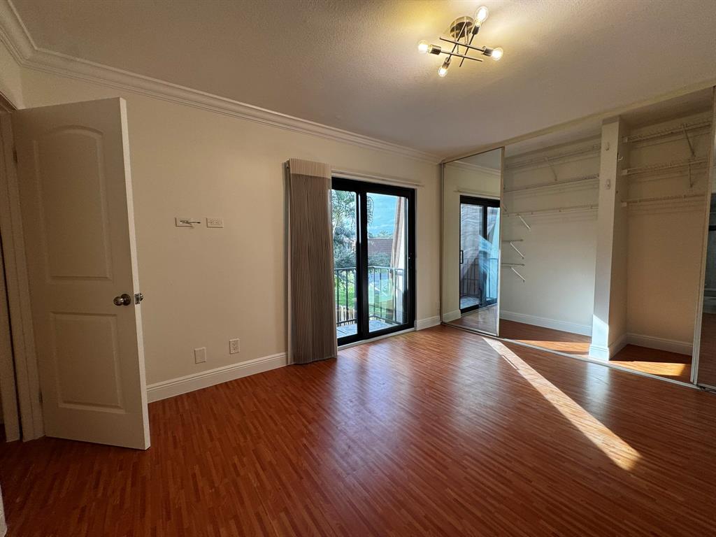 3205 Spanish Wells Drive, Unit C Delray Beach, FL 33445 - Photo 5 of 20 a view of an empty room with wooden floor and a window