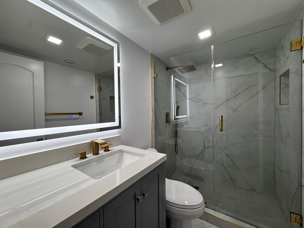 3205 Spanish Wells Drive, Unit C Delray Beach, FL 33445 - Photo 6 of 20 a bathroom with a sink a toilet and shower