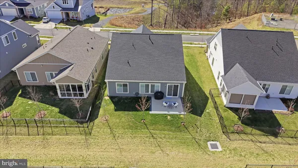a house with yard and a car parked in front of it