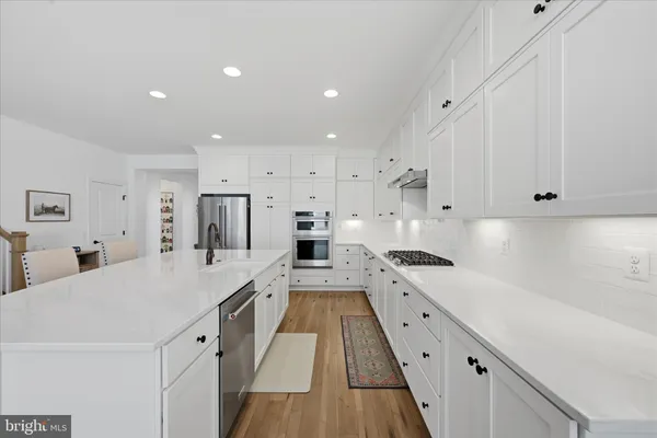 a view of a dining room with furniture a fireplace and wooden floor
