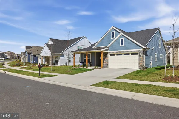 a view of a house with backyard sitting area and garden