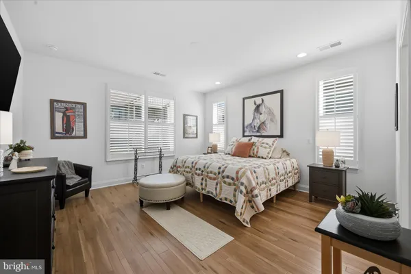 a view of a patio with couches table and chairs and garden