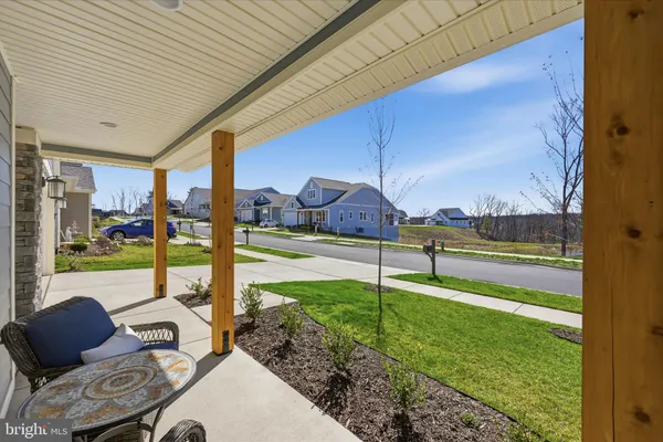 a view of a couches in the patio with a yard