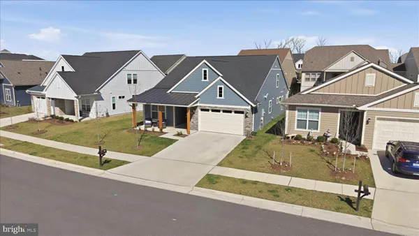 an aerial view of a house with garden space and lake view