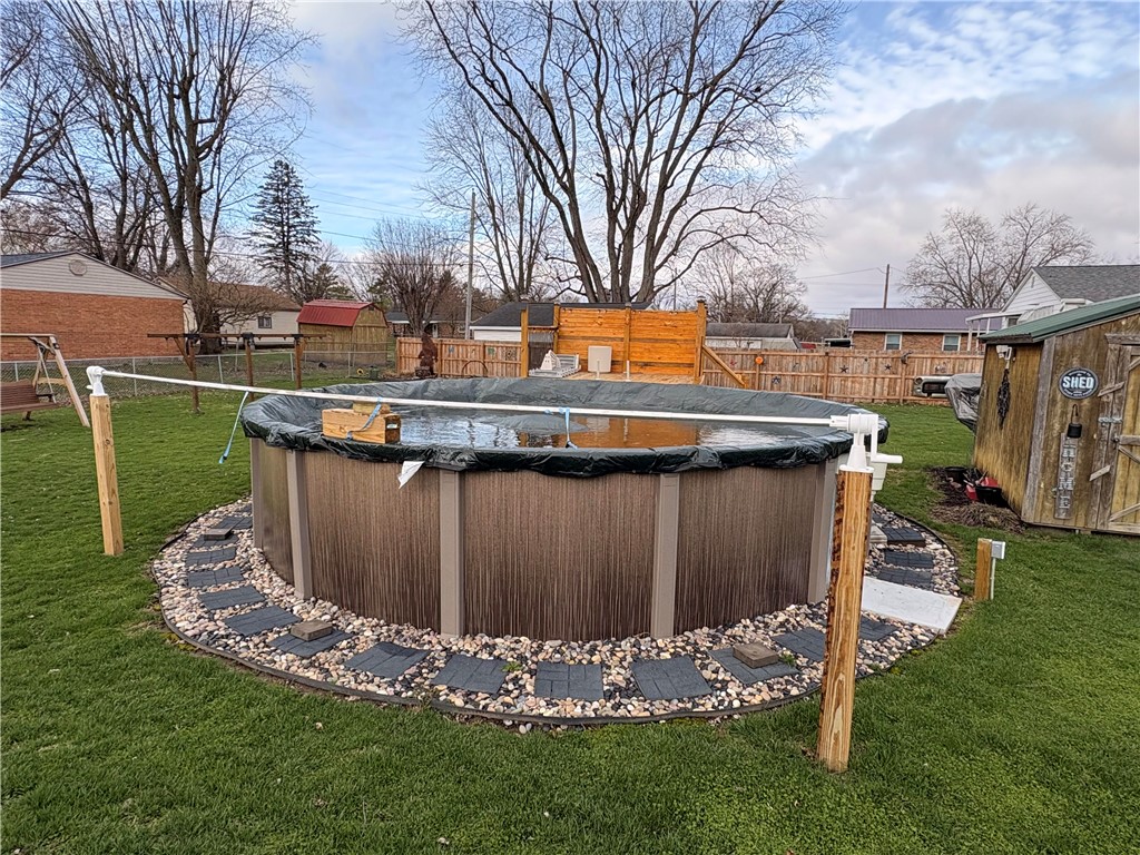 321 Liberty Street Eaton, OH 45320 - Photo 14 of 34 This spacious backyard features an inviting above-ground pool, perfect for outdoor enjoyment and relaxation.