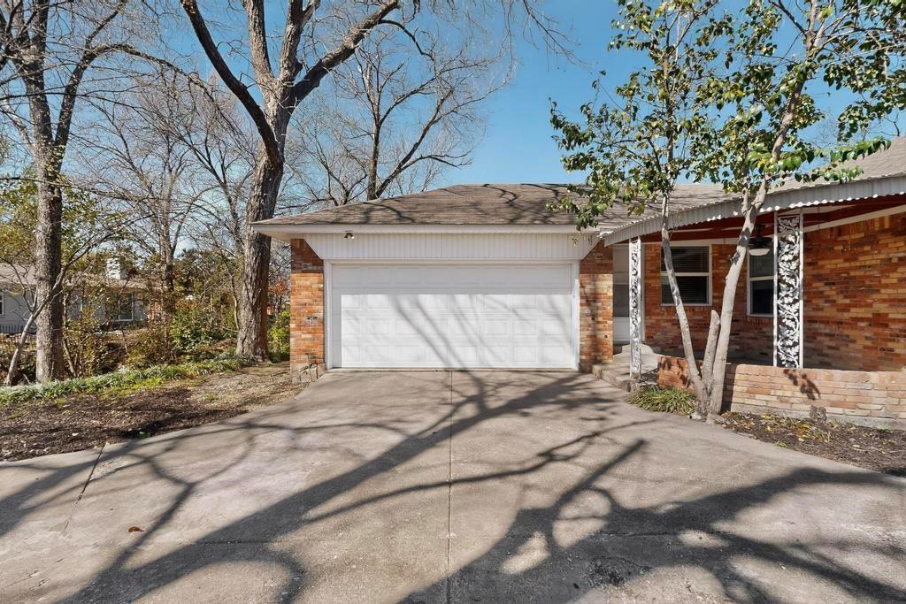 2120 Healey Drive Dallas, TX 75228 - Photo 37 of 39 a view of a house with a yard and garage