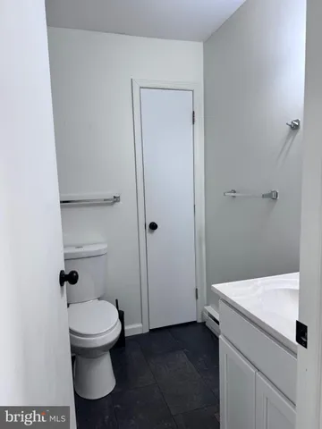 a white toilet sitting next to a bathroom sink