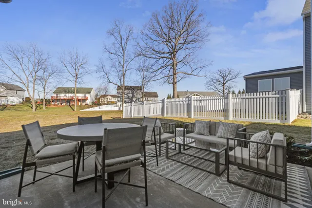 a view of a patio with iron fence