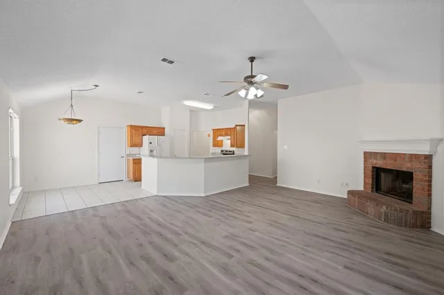 a view of a kitchen with a sink cabinet and a fireplace