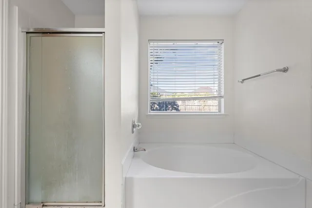 a white bath tub sitting next to a window