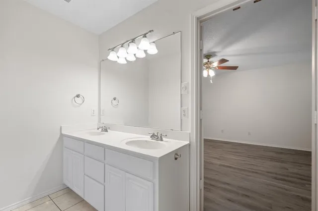 a bathroom with a sink vanity and mirror