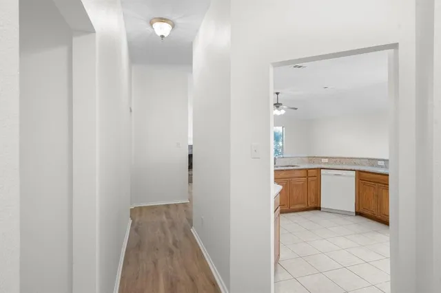 a view of a bathroom with sink mirror and window