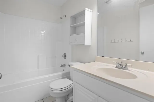 a bathroom with a sink toilet vanity and shower