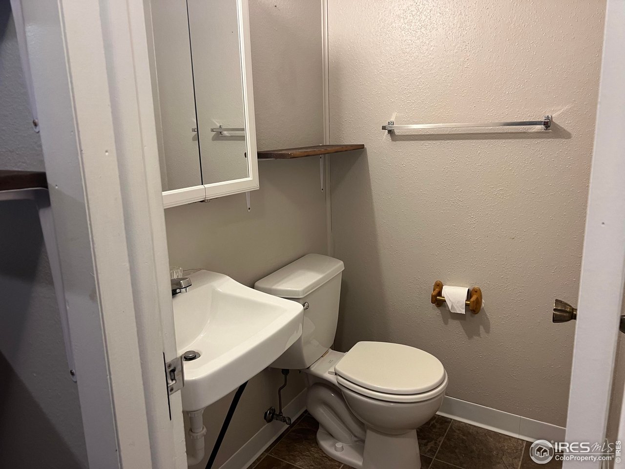 1705 Heatheridge Road, Unit 104 Fort Collins, CO 80526 - Photo 11 of 14 a white toilet sitting next to a bathroom sink