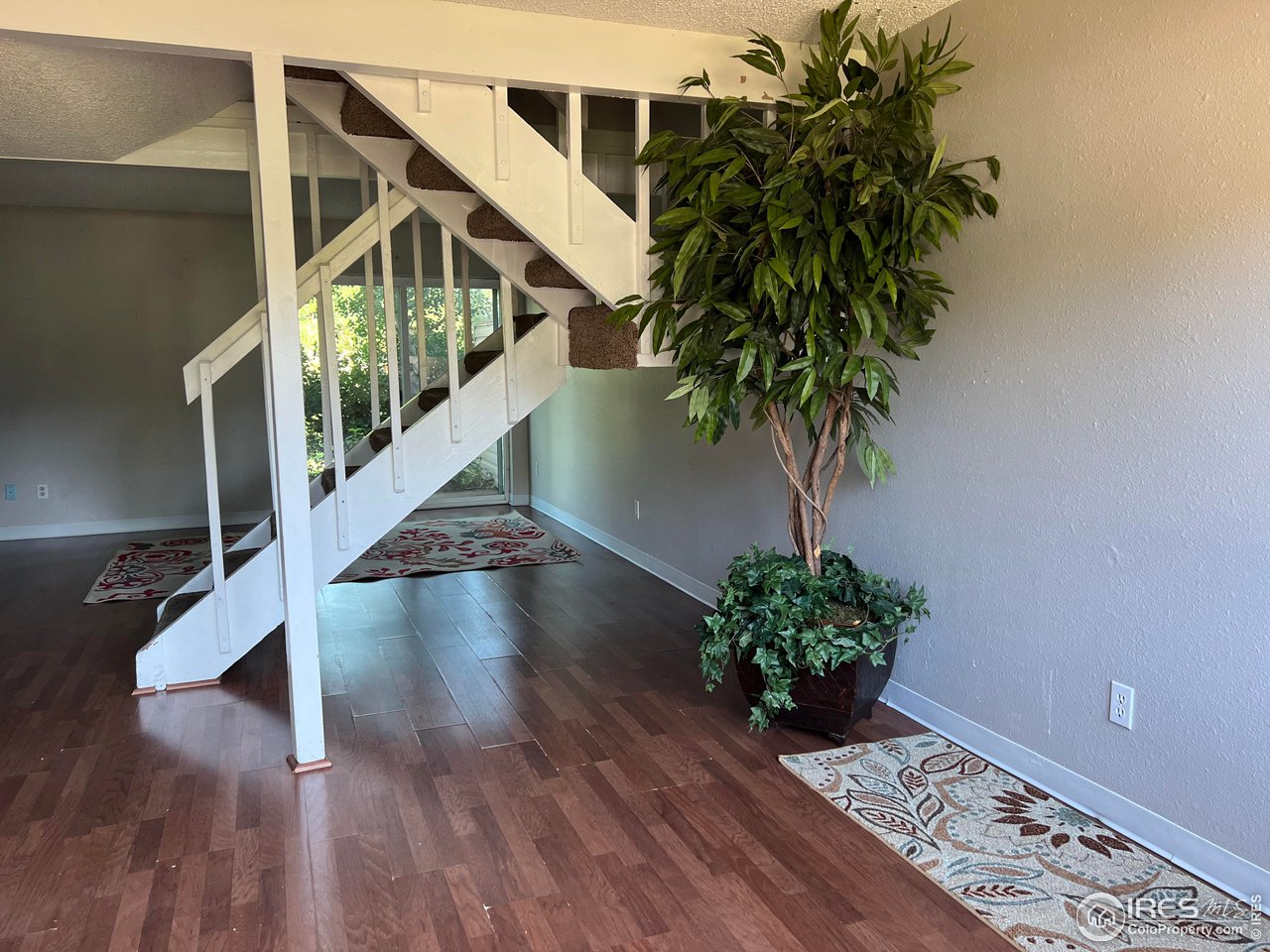 1705 Heatheridge Road, Unit 104 Fort Collins, CO 80526 - Photo 3 of 14 a view of entryway with wooden floor