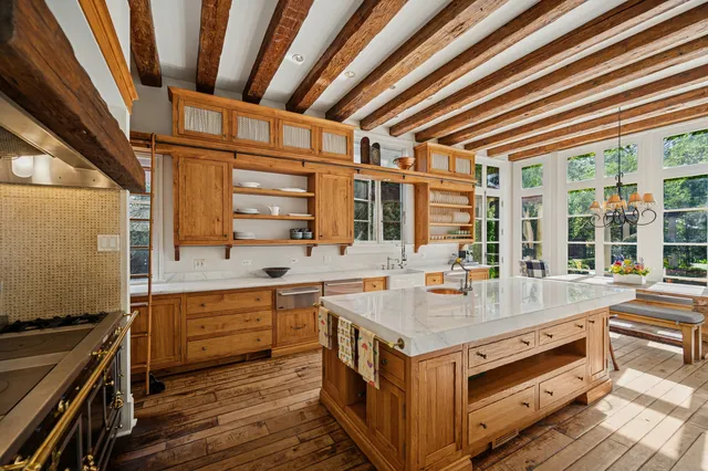 a spacious bathroom with a granite countertop sink mirror and bathtub