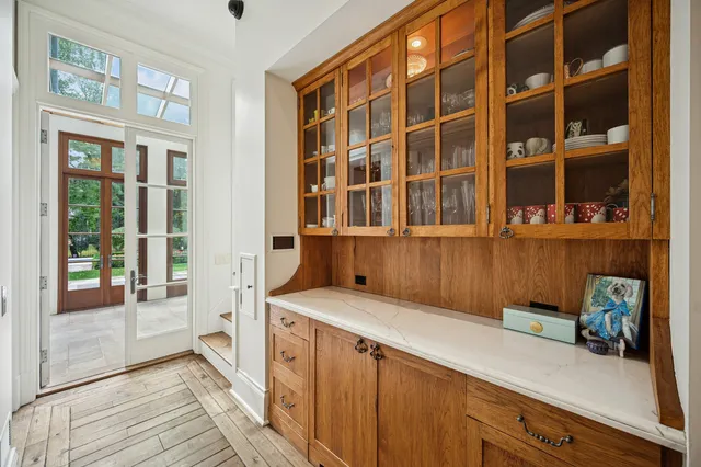 a living room with furniture a flat screen tv and a floor to ceiling window