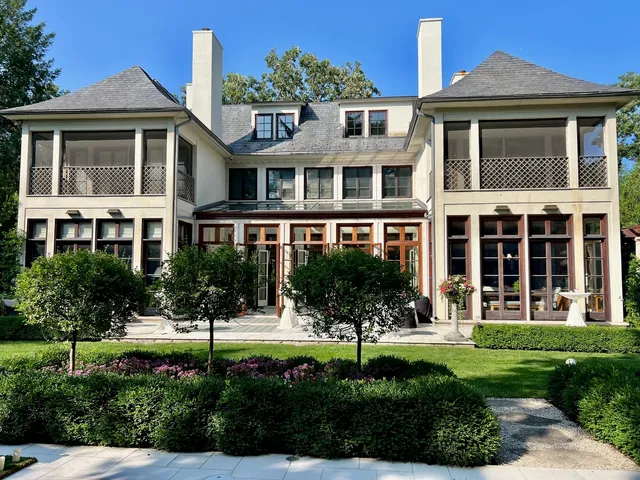 a view of house with swimming pool next to a yard