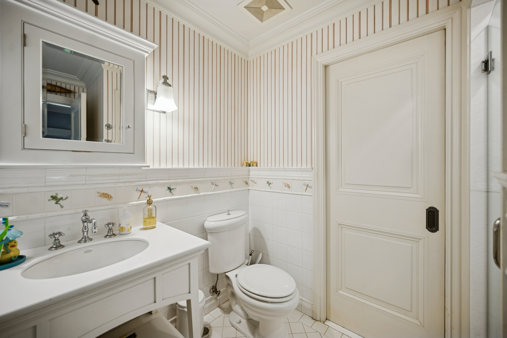 528 Roslyn Road Kenilworth, IL 60043 - Photo 45 of 63 a bathroom with a sink a toilet and mirror
