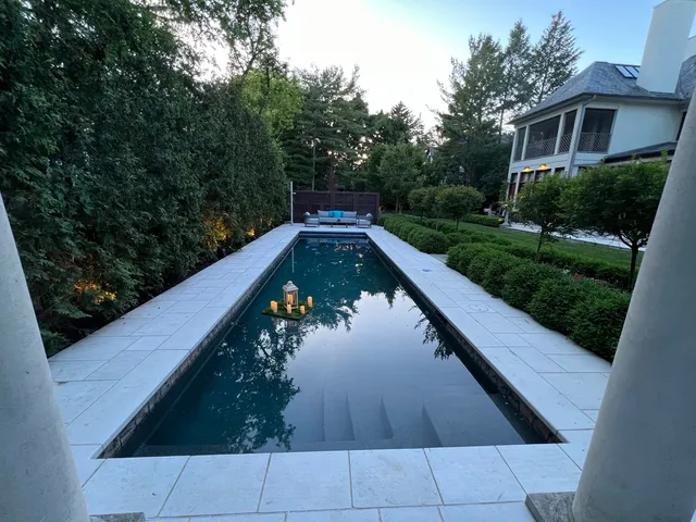 a front view of a house with a yard and trees
