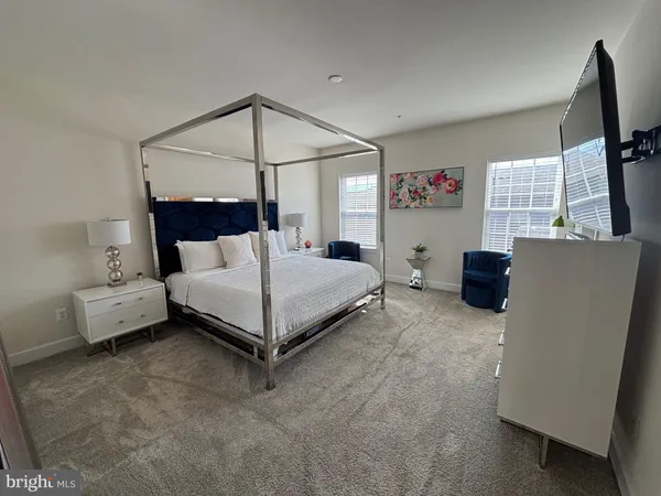 a bedroom with a bed and a television