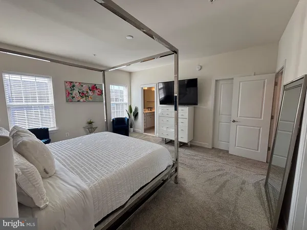 a bedroom with a bed and a flat tv screen