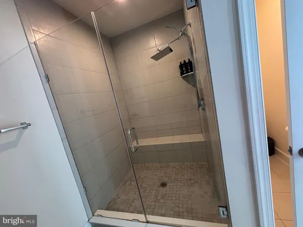 a bathroom with a glass door shower