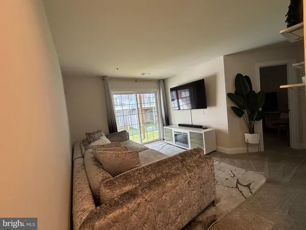 a bedroom with a bed a flat screen tv and window