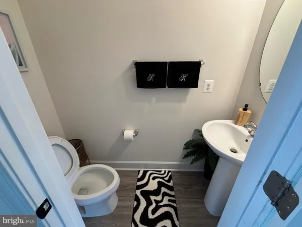 a bathroom with a toilet mirror and a sink