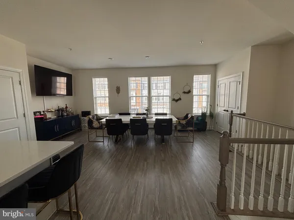 a living room with lots of furniture a window and a flat screen tv