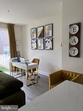 a living room with furniture and wall paintings