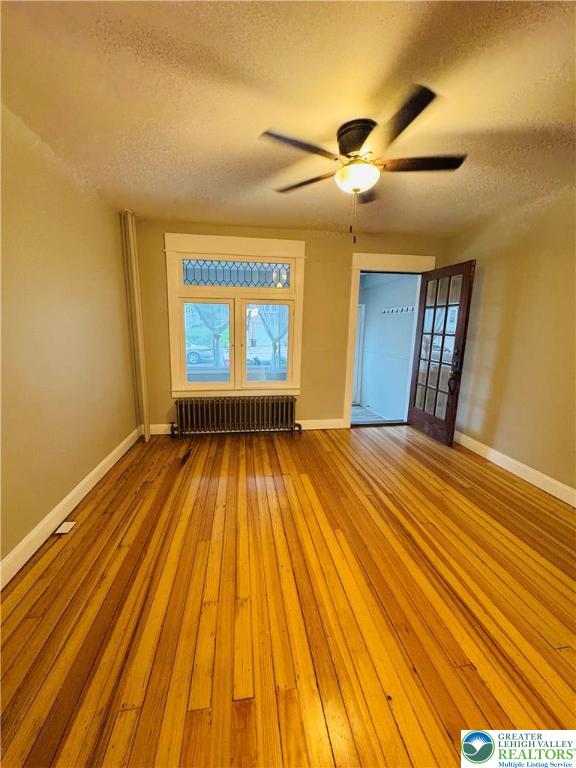 823 Spring Street Bethlehem, PA 18018 - Photo 6 of 39 a view of a room with wooden floor ceiling fan and window