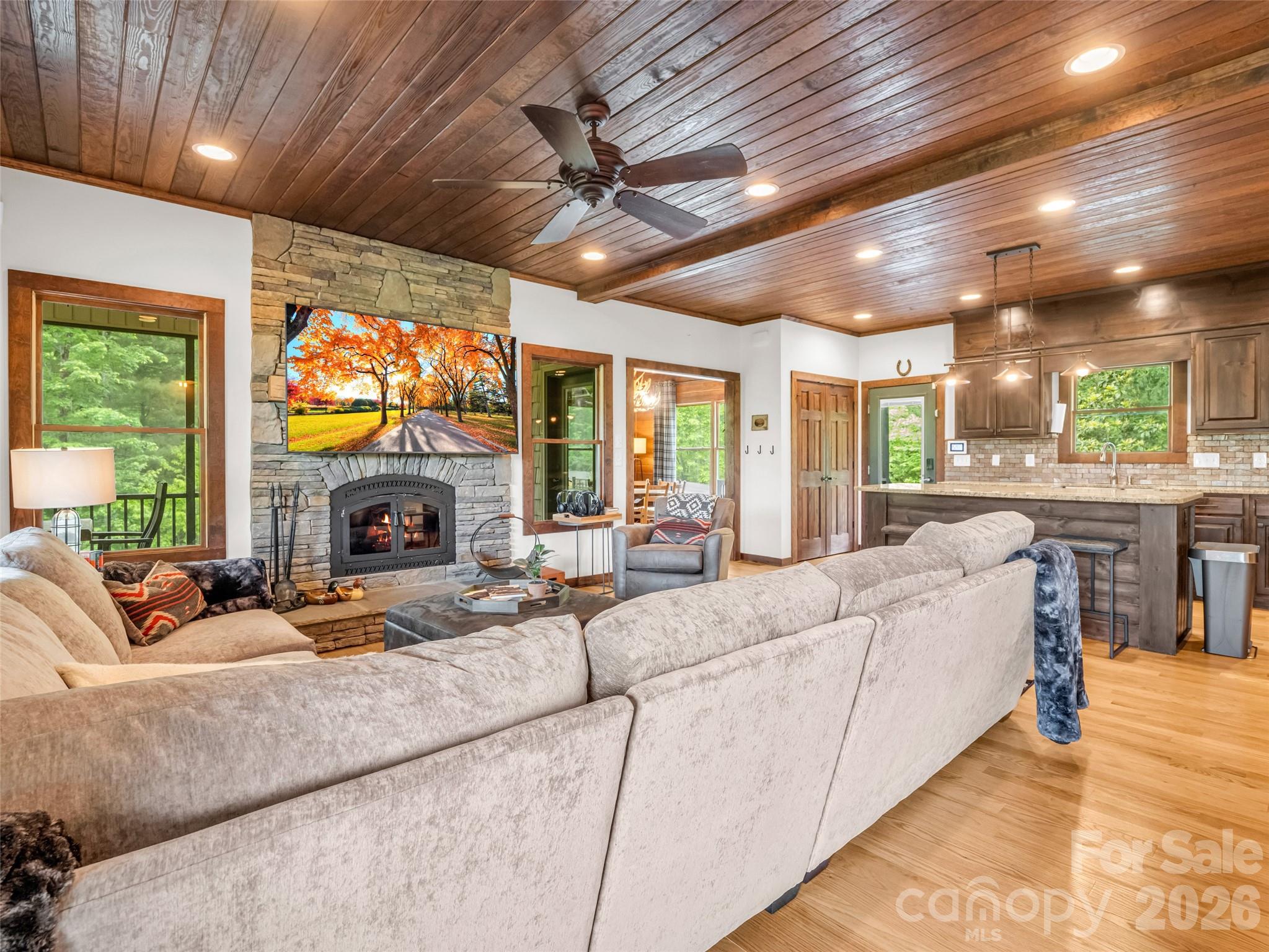 139 Picnic Point Road Lake Lure, NC 28746 - Photo 12 of 41 a living room with furniture a fireplace and a flat screen tv