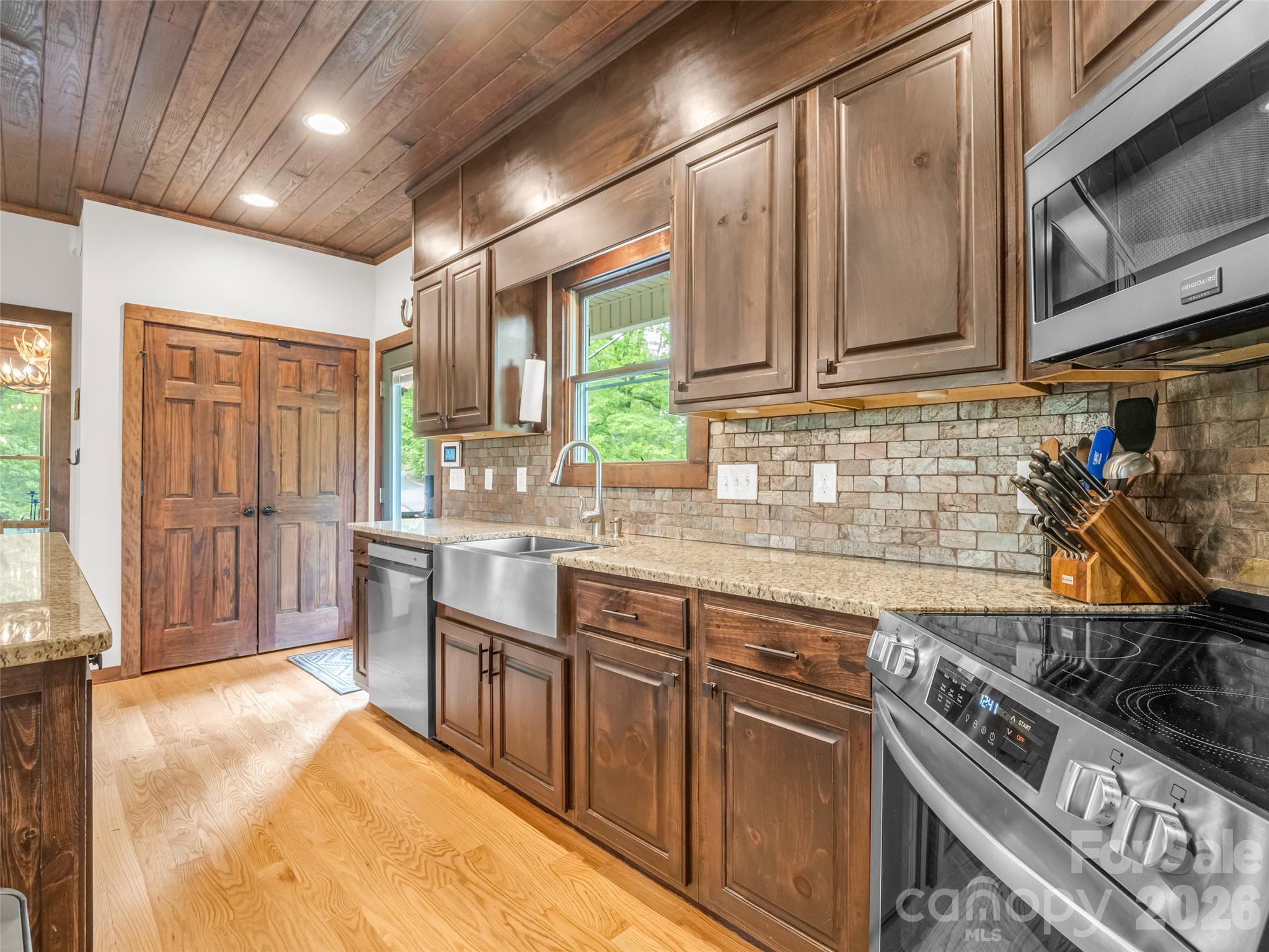 139 Picnic Point Road Lake Lure, NC 28746 - Photo 14 of 41 a kitchen with stainless steel appliances granite countertop a stove and a sink