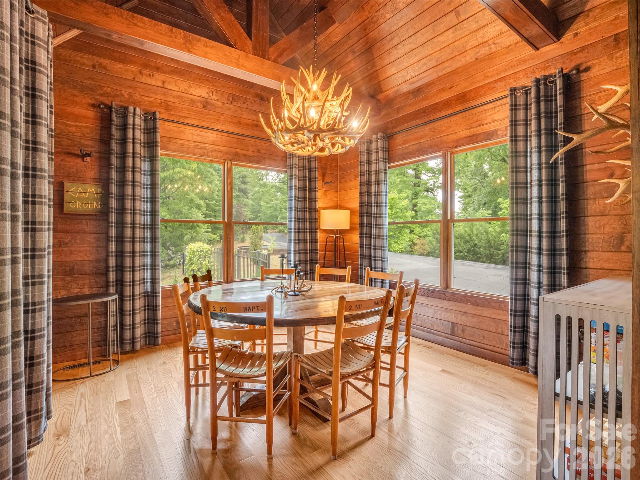 139 Picnic Point Road Lake Lure, NC 28746 - Photo 15 of 41 a view of an outdoor dining space with furniture and wooden floor